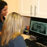 Interior photo: Oral Surgery Staff at front desk with digital patient records